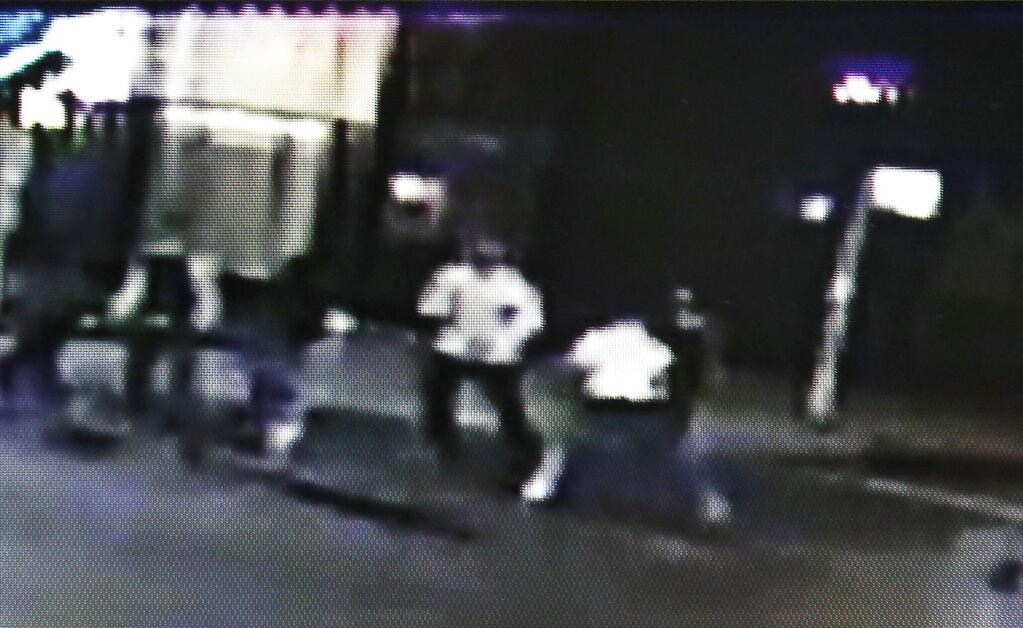 This frame from video provided by A&P Liquors, shows a group of people, including U.S. airman Spencer Stone, fighting outside a bar in Sacramento, Calif., in the early hours of Thursday, Oct. 8, 2015. Stone, who helped stop a terror attack on a French train in August, was stabbed and wounded, but is expected to survive. (A&P Liquors via AP)