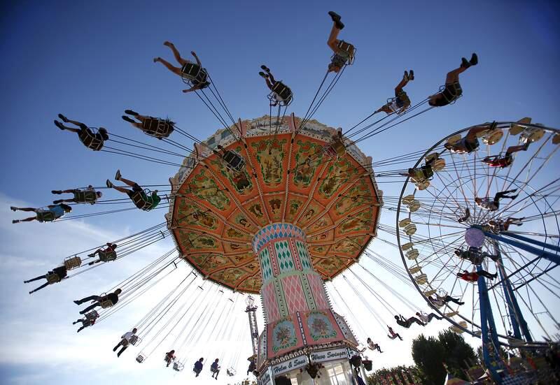 Fair attendees swing through the air on the Wave Swinger ride at the Sonoma County Fair, Aug. 12, 2011. (Press Democrat file, 2011)