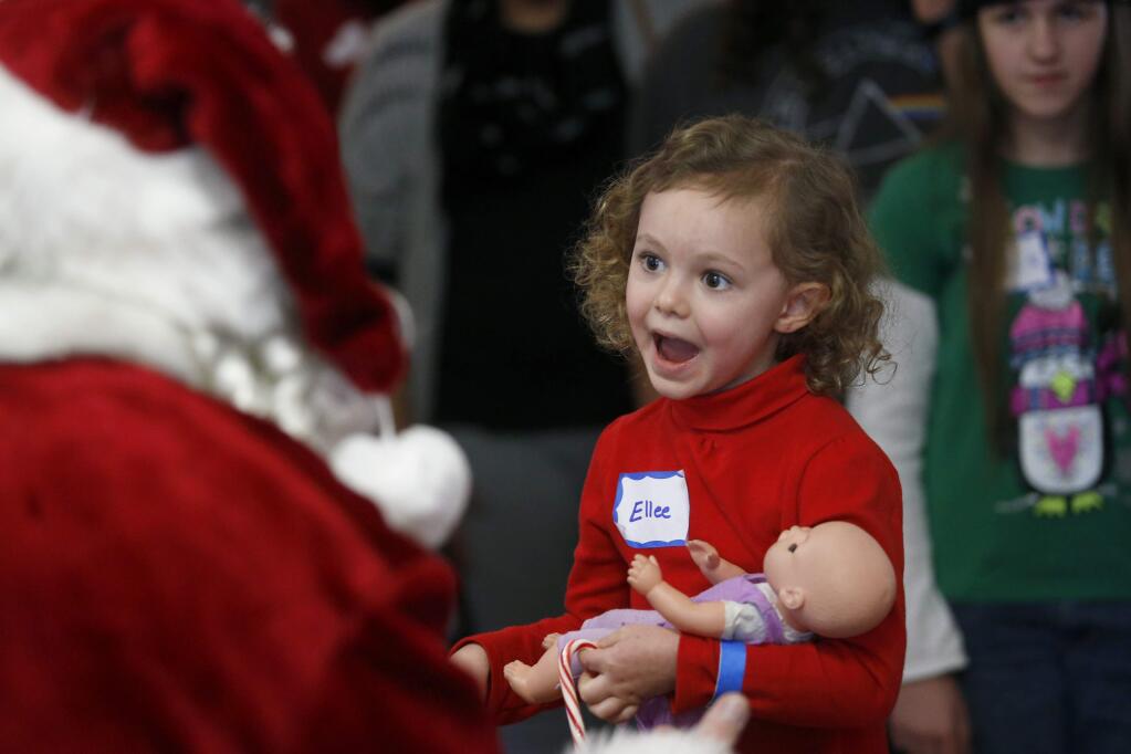 Ellee Meckfessel, 3, talks with Santa Claus during the 'Christmas in Lower Lake' event at Brick Hall on Sunday, Dec. 4, 2016 in Lower Lake, California . (BETH SCHLANKER/The Press Democrat)
