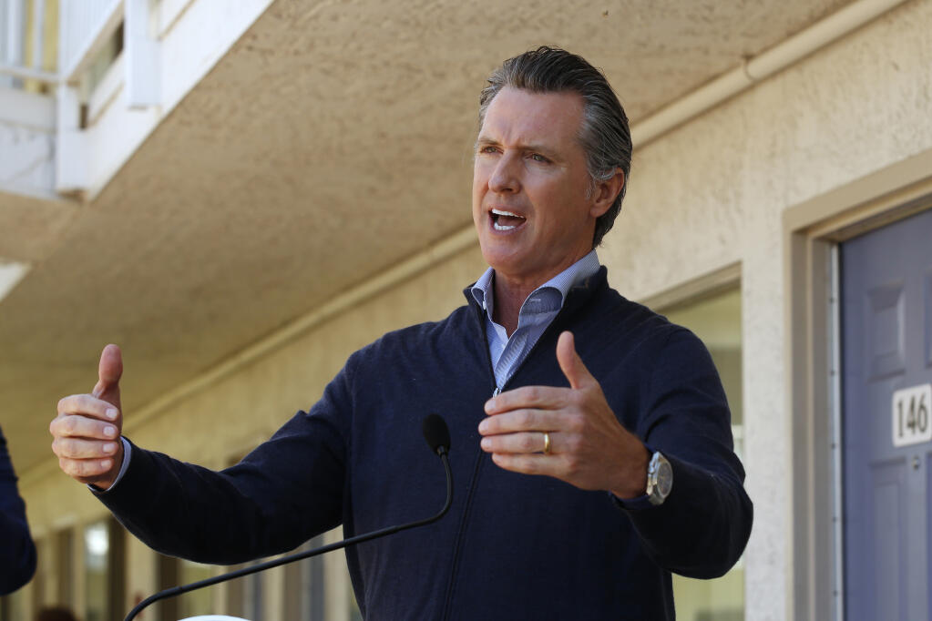 Gov. Gavin Newsom gives an update on the state's initiative to provide housing for homeless Californians to help stem the coronavirus, during a visit to a Motel 6 participating in the program in Pittsburg, Calif., Tuesday, June 30, 2020. (AP Photo/Rich Pedroncelli, Pool)