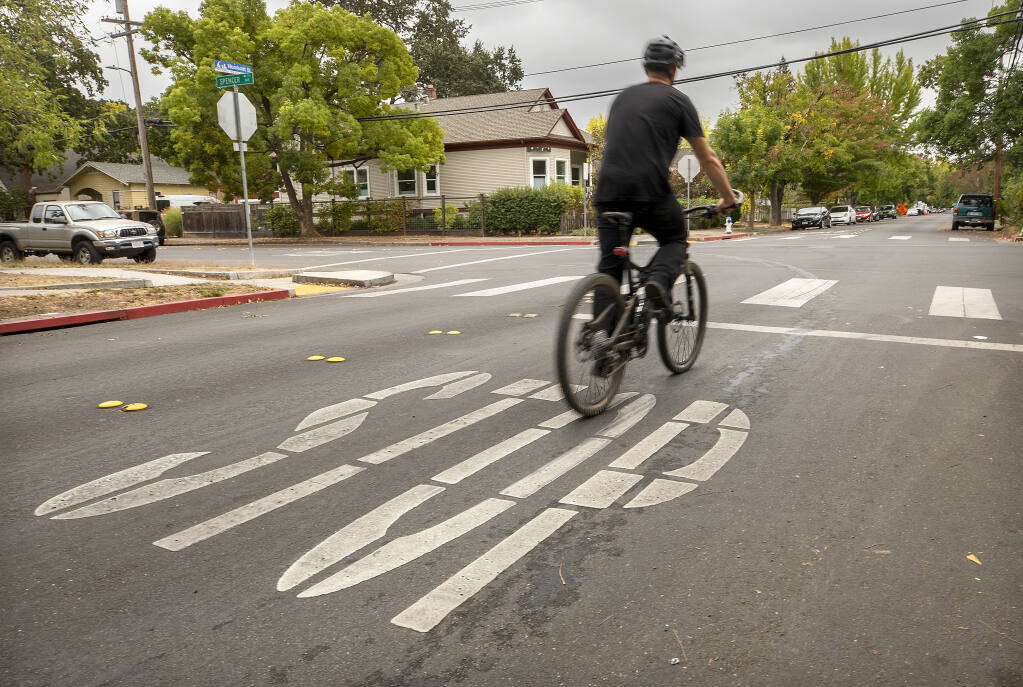 Bicyclists along the Humboldt Street bicycle boulevard in Santa Rosa won't have to stop for the stop sign if Gov. Gavin Newson signs a bill to legalize "Idaho stops."  Idaho stops are when cyclists decelerate but do not fully stop at stop signs, unless there is traffic.  (John Burgess / The Press Democrat)