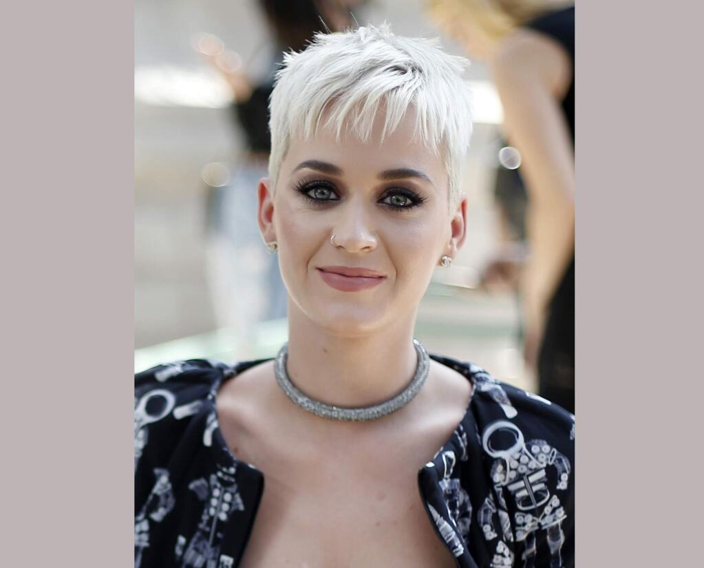 FILE - In this July 4, 2017 file photo, singer Katy Perry appears at the Chanel Haute Couture Fall/Winter 2017/2018 fashion collection presented in Paris. MTV announced Thursday that Perry would host the Aug. 27 event at the Forum in Inglewood, California. Perry is nominated for five Moonmen, including best pop video for ‚ÄúChained to the Rhythm.‚Äù (AP Photo/Thibault Camus, File)