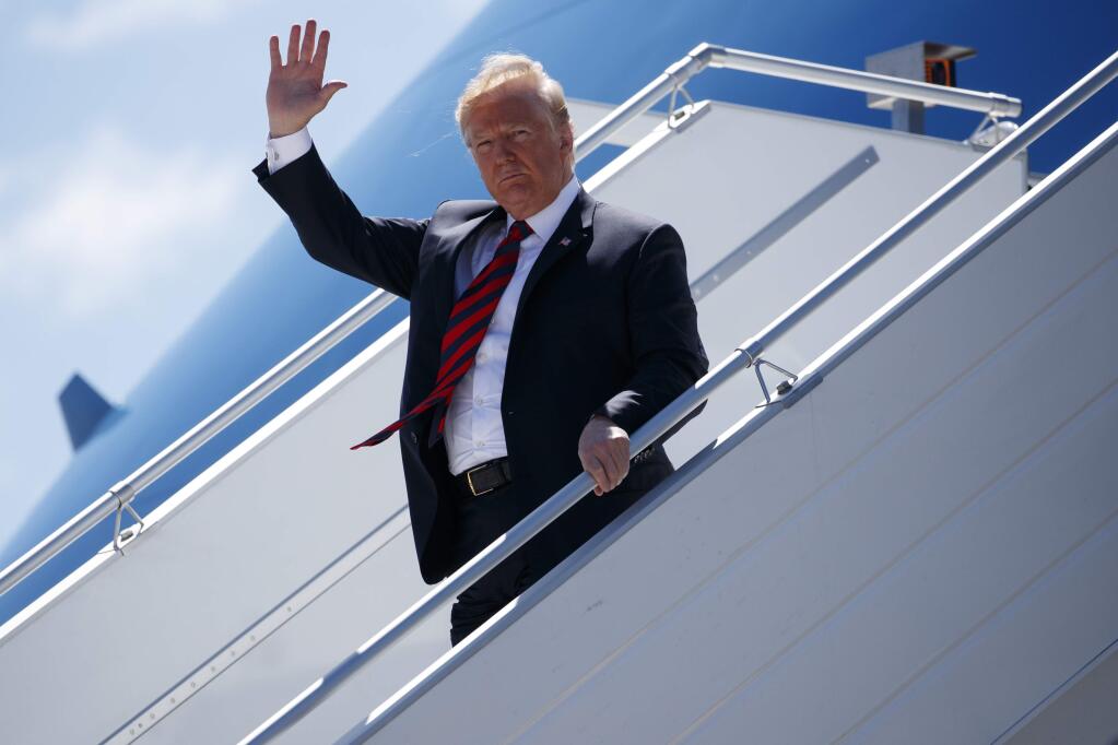 President Donald Trump steps off Air Force One as he arrives for the G7 Summit, Friday, June 8, 2018, in Canadian Forces Base Bagotville, Canada. (AP Photo/Evan Vucci)