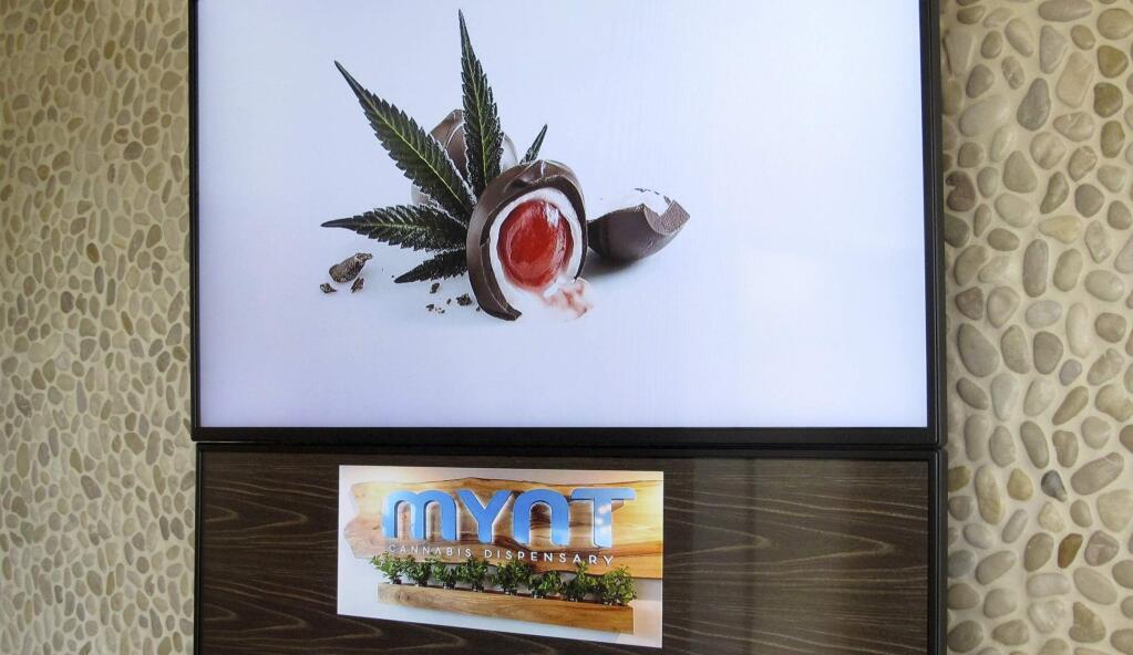 A menu sign that shows some of the edible marijuana products for sale is pictured at the Mynt Cannabis Dispensary in downtown Reno, Nev., is pictured Wednesday, June 21, 2017. (AP Photo/Scott Sonner)