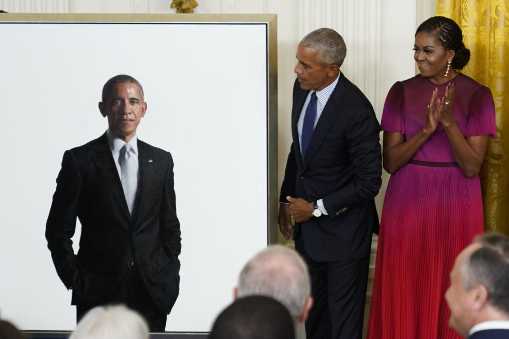 Former President Barack Obama looks at his official White House portrait with former first lady Michelle Obama during a ceremony in the East Room of the White House, Wednesday, Sept. 7, 2022, in Washington. (AP Photo/Andrew Harnik)