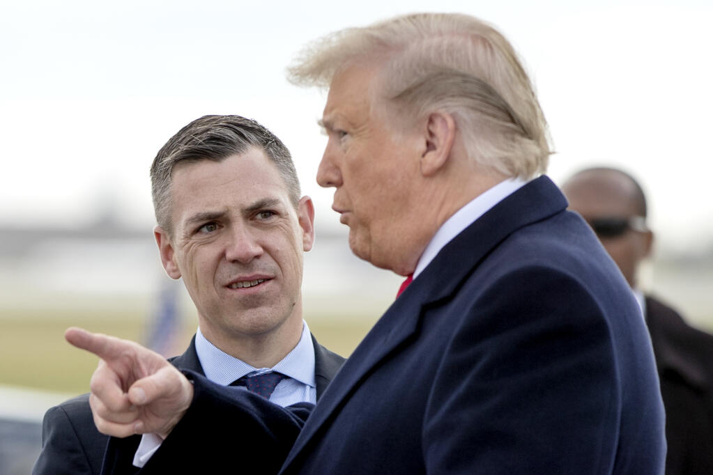 FILE - In this Oct. 27, 2018 file photo, President Donald Trump is greeted by Rep. Jim Banks, R-Ind., as he arrives at Indianapolis International Airport in Indianapolis. House Speaker Nancy Pelosi is rejecting two Republicans tapped by House GOP Leader Kevin McCarthy to sit on a committee investigating the Jan. 6 Capitol insurrection. She cited the “integrity” of the investigation. Pelosi said in a statement Wednesday that she would not accept the appointments of Indiana Rep. Jim Banks, whom McCarthy picked to be the top Republican on the panel, or Ohio Rep. Jim Jordan. Both are close allies of former President Donald Trump.  (AP Photo/Andrew Harnik)