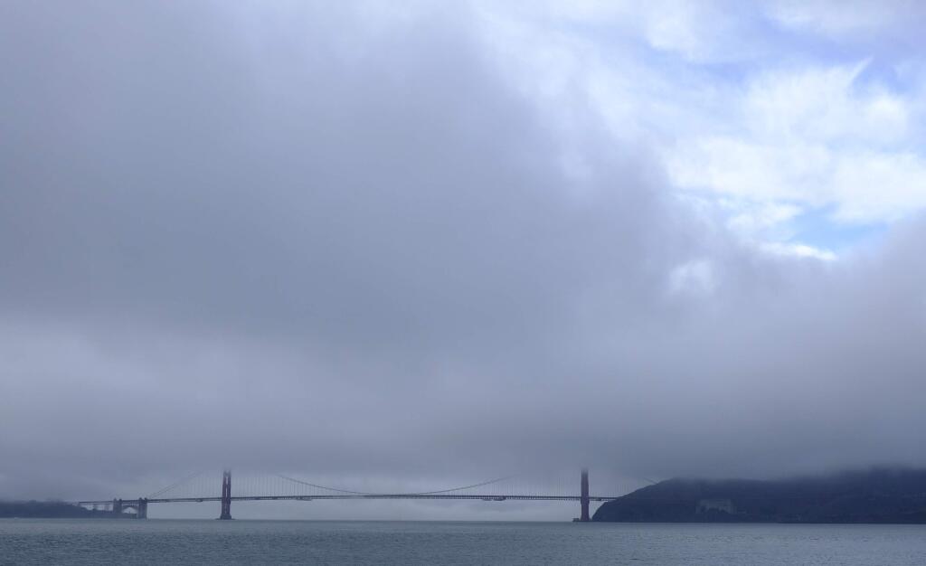 A break in the weather appears over the Golden Gate Bridge Wednesday, Nov. 28, 2018, in San Francisco. Forecasters say California will see widespread rain and heavy Sierra Nevada snowfall starting late Wednesday that could create travel problems and unleash damaging runoff from wildfire burn scars. (AP Photo/Eric Risberg)