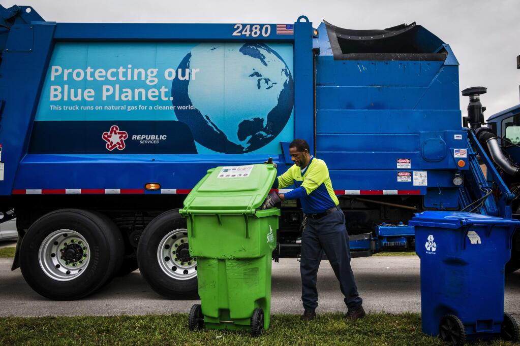 Eric Griffin while on a recycling collection route in Sunrise, Fla., March 15, 2019. With China no longer accepting used plastic and paper, communities are facing steep collection bills, forcing them to end their programs or burn or bury more waste. (Scott McIntyre/The New York Times)
