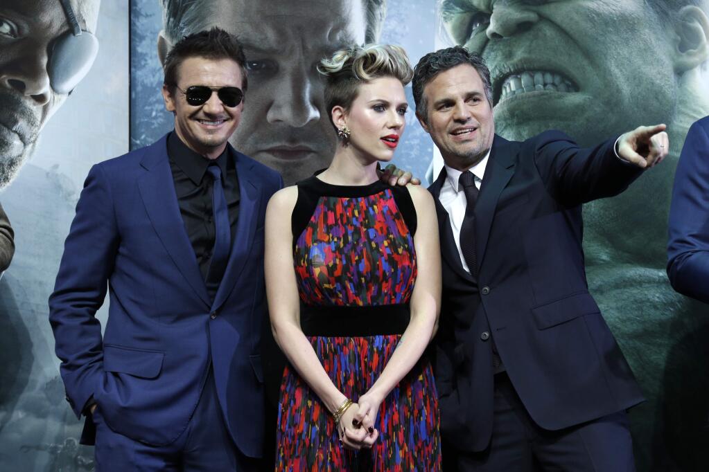 Jeremy Renner, Scarlett Johansson and Mark Ruffalo pose for photographers upon arrival at the premiere for the film 'The Avengers Age of Ultron' in London, Tuesday, 21 April, 2015. (Photo by Joel Ryan/Invision/AP)
