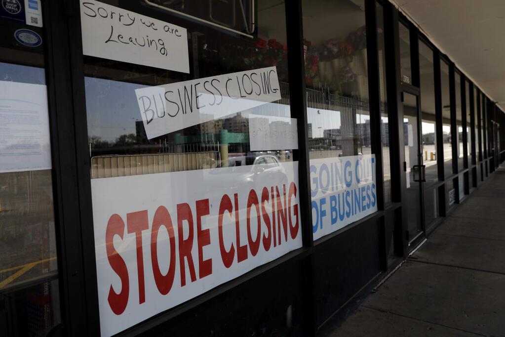 A sign announces a store closing in Niles, Ill., Wednesday, May 13, 2020. (AP Photo/Nam Y. Huh)