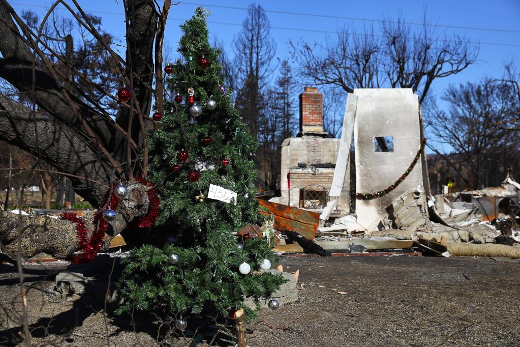 A burned home on Brighton Drive is decorated for Christmas, in Larkfield-Wikiup on Thursday, December 21, 2017. (Christopher Chung/ The Press Democrat)