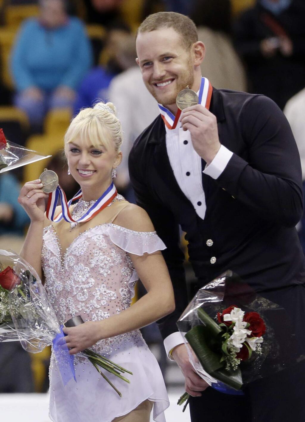 FILE - In this Jan. 11, 2014, file photo, bronze medalists Caydee Denney and John Coughlin, of the United States, smile during an award ceremony at the U.S. Figure Skating Championships in Boston. Coughlin, a two-time U.S. pairs champion recently suspended from figure skating, has died. He was 33. U.S. Figure Skating released a statement Saturday, Jan. 19, 2019, and cited his sister, Angela Laune. The sister said in a Facebook post that her 'wonderful, strong, amazingly compassionate brother John Coughlin took his own life. ... I have no words.' There were no further details. (AP Photo/Steven Senne, File)