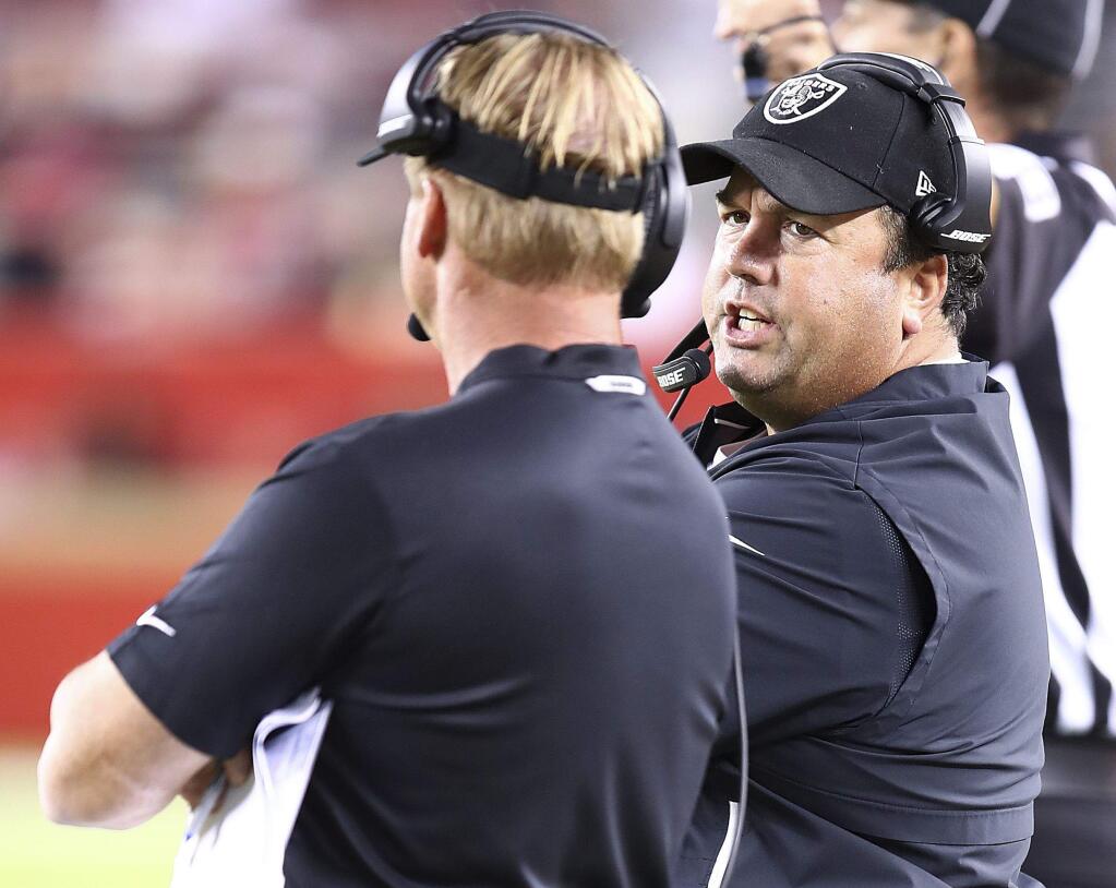 Oakland Raiders defensive coordinator Paul Guenther, right, talks with head coach Jon Gruden during the second half against the San Francisco 49ers in Santa Clara, Thursday, Nov. 1, 2018. (AP Photo/Ben Margot)