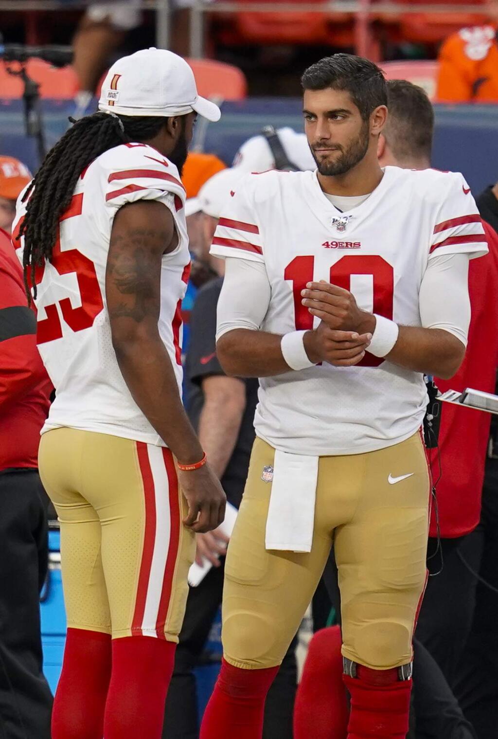 San Francisco 49ers quarterback Jimmy Garoppolo, right, and Richard Sherman talk on the sideline during a preseason game between the Denver Broncos and the San Francisco 49ers, Monday, Aug. 19, 2019, in Denver. (AP Photo/Jack Dempsey)