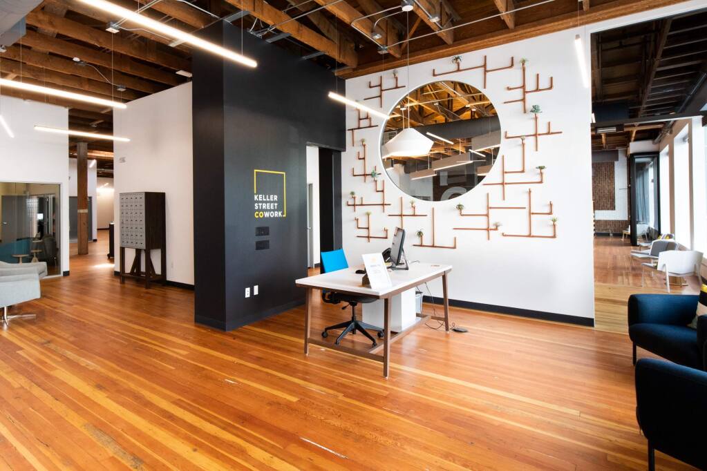 The rich wood flooring and exposed ceiling of this restored 1920s warehouse form the setting for flexible work environments at Keller Street CoWork helping to redefine the future of work. (COURTESY OF BELLI ARCHITECTURAL GROUP) 2018