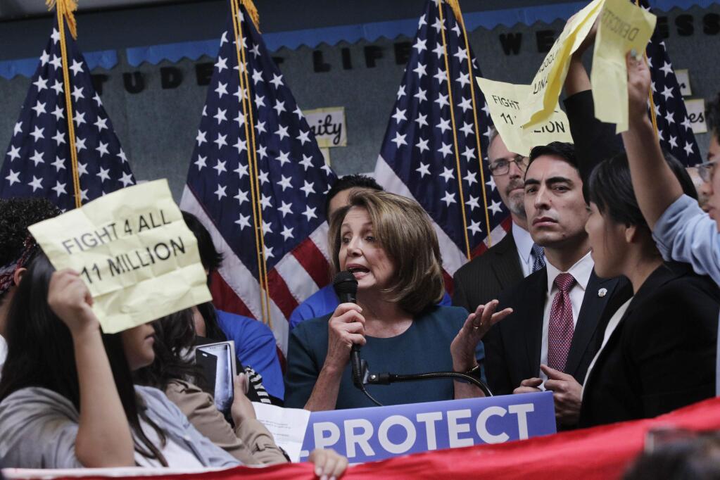 U.S. House Minority Leader Nancy Pelosi tries to talk as protesters demonstrate during a press conference on the DREAM ACT on Monday, Sept. 18, 2017 in San Francisco, Calif. Several dozen young immigrants shouted down Pelosi, the top Democrat in the U.S. House, on Monday during an event in San Francisco, following her recent conversations with President Donald Trump over the future of a program that grants many of them legal status. (Lea Suzuki /San Francisco Chronicle via AP)