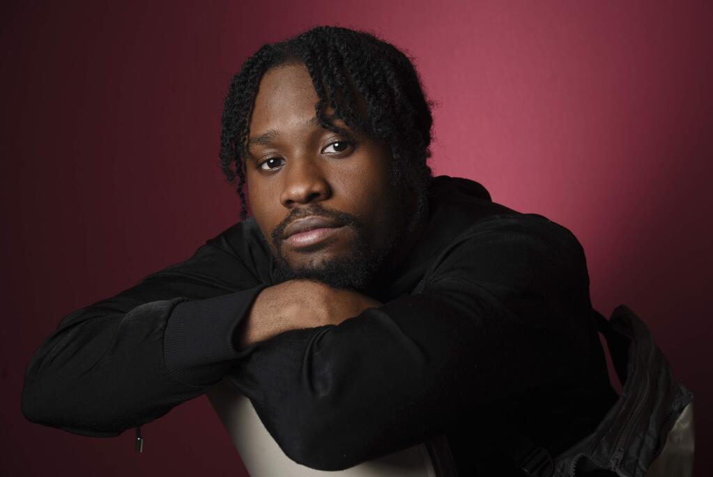 In this Nov. 30, 2018 photo, Shameik Moore, a cast member in 'Spider-man: Into the Spider-Verse,' poses for a portrait at the Four Seasons Hotel in Los Angeles. (Photo by Chris Pizzello/Invision/AP)