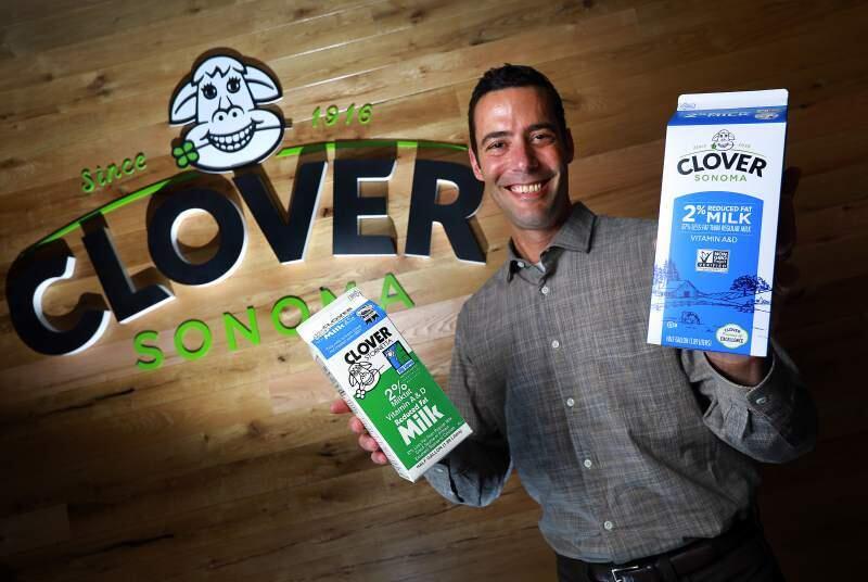 The 'udder' excitement of it all: Marcus Benedetti with the old and new cartons of 2 percent.(John Burgess/Press Democrat)
