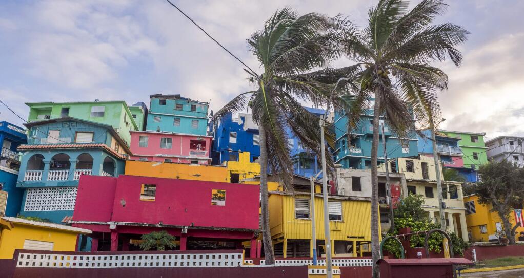 Buildings are painted in vibrant colors along a street in La Perla, a historic shanty town in Puerto Rico. (Saara Snow)