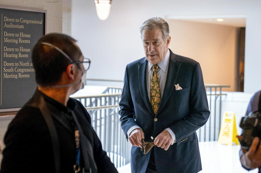 FILE - Paul Pelosi, right, the husband of House Speaker Nancy Pelosi, of California, follows his wife as she arrives for her weekly news conference on Capitol Hill in Washington, Thursday, March 17, 2022. (AP Photo/Andrew Harnik, File)