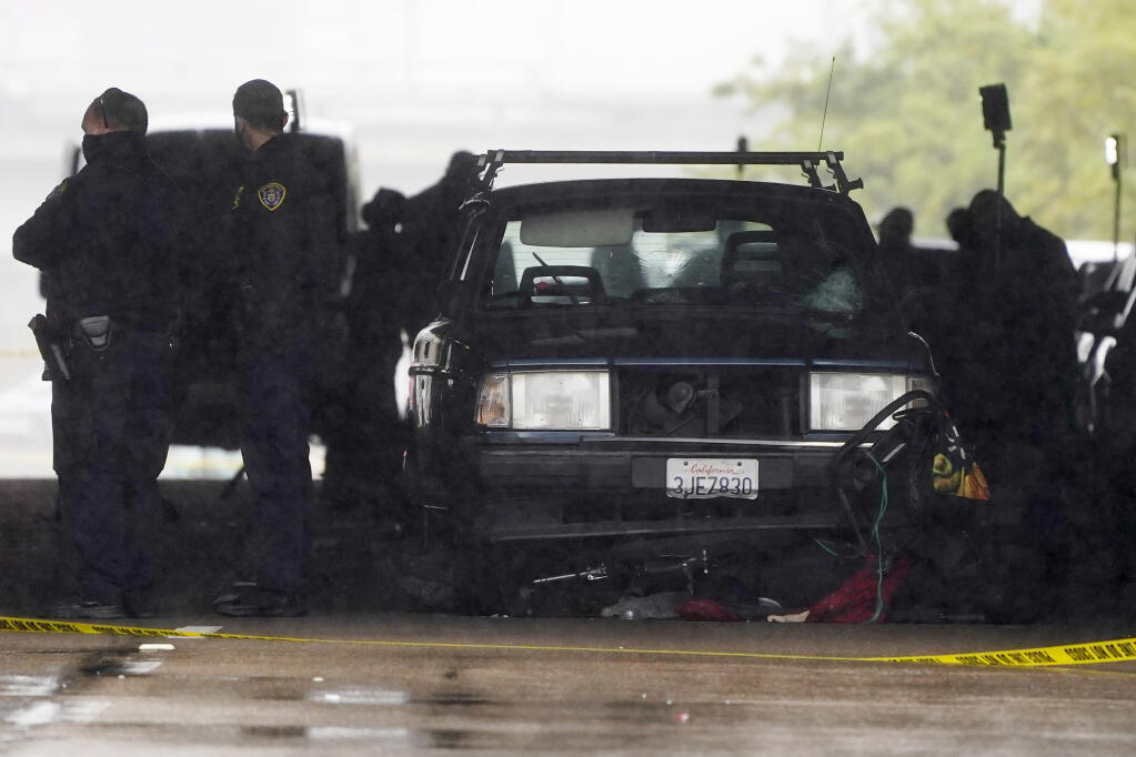 A car involved in a deadly accident sits at the scene Monday, March 15, 2021, in San Diego. A driver plowed through a crowd on a sidewalk in downtown San Diego on Monday morning, killing three people and injuring six others, including two who are hospitalized in critical condition, police said. (AP Photo/Gregory Bull)