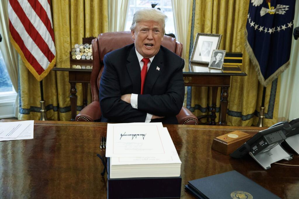 FILE - In this Dec. 22, 2017, file photo, President Donald Trump speaks with reporters after signing a tax bill and resolution in the Oval Office of the White House in Washington. California Gov. Gavin Newsom signed a law Tuesday, July 30, 2019, requiring presidential candidates to release their tax returns to appear on the state's primary ballot, a move aimed squarely at Republican President Donald Trump. (AP Photo/Evan Vucci, File)