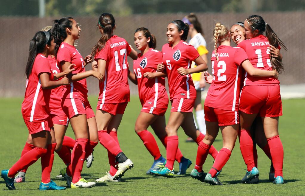 Teammates congratulate April Gomez, right, on her second-half goal in Santa Rosa Junior College's 3-0 victory over College of the Redwoods on Friday, Sept. 14. (John Burgess/The Press Democrat)