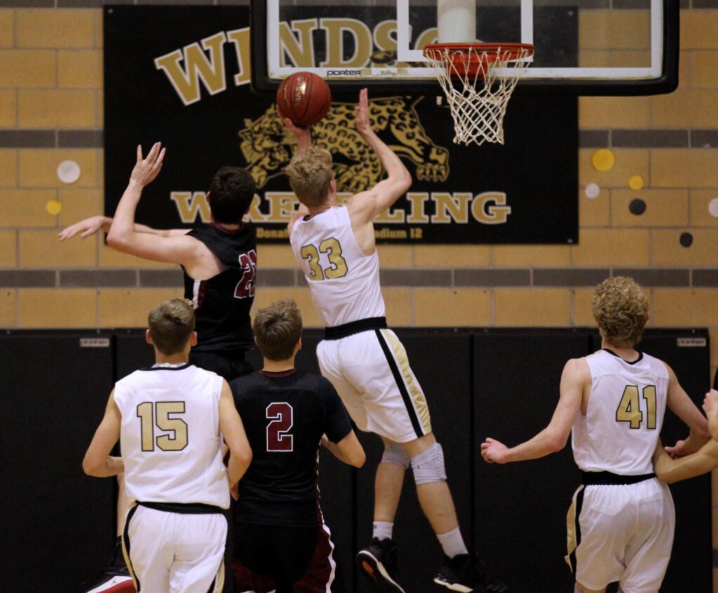 Windsor's Riley Smith (33) goes for a shot with his brother Justin Smith (41) watching, while Healdsburg's Trey Chapman (21) defends during second-half basketball in Windsor on Tuesday, Dec. 5, 2017. (Photo by Darryl Bush / For The Press Democrat)