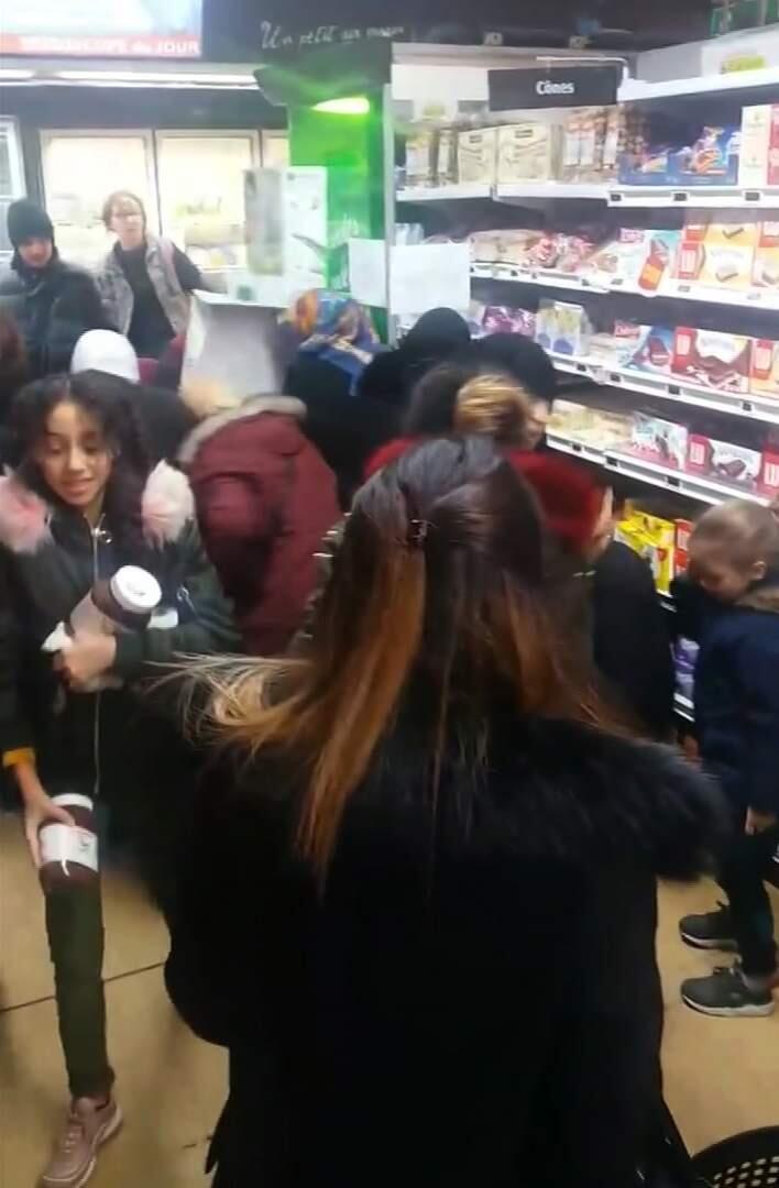 In this image taken from video a customer carries away pots of Nutella the chocolate and hazelnut spread, as others congregate around display of the product in a supermarket in Toulon southern France on Thursday Jan. 25, 2018. Brawls broke out in French supermarkets on Thursday as shoppers scrambled to get their hands on discounted pots of the chocolate and hazelnut spread Nutella. (AP Photo)