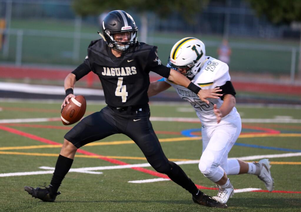 Windsor's quarterback Billy Boyle attempts to pass as he is tackled for a loss by Livermore's Evan Nystrom during the first half on Friday, Sept. 6, 2019. (Photo by Darryl Bush / For The Press Democrat)