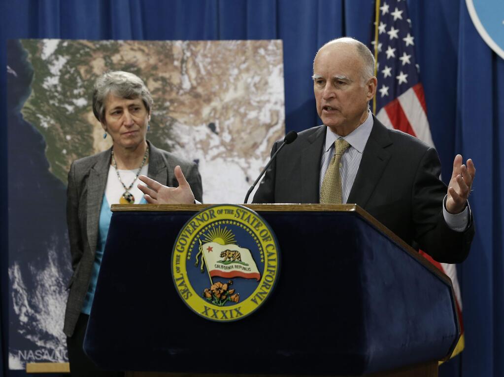 Gov. Jerry Brown responds to a question concerning the announcement by U.S. Secretary of the Interior Sally Jewell, left, that the federal government is offering up to $50 million for drought relief in western states during a news conference at the Capitol in Sacramento, Calif., Friday, Feb. 6, 2015. The additional funding includes about $20 million for California's Central Valley Water Project for efforts such as water transfers, drought monitoring for endangered species and diversifying water supplies.(AP Photo/Rich Pedroncelli)