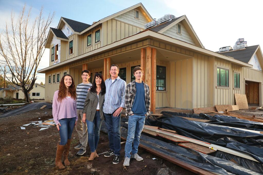 Jennifer and Miles Harrison, with their children Riley, 21, left, Jack, 16, and Maxwell, 18, are in the midst of rebuilding their Hidden Valley neighborhood home in Santa Rosa after it was destroyed by the Tubbs fire last year. The Harrison's hope their home will be finished next March. (Christopher Chung/ The Press Democrat)