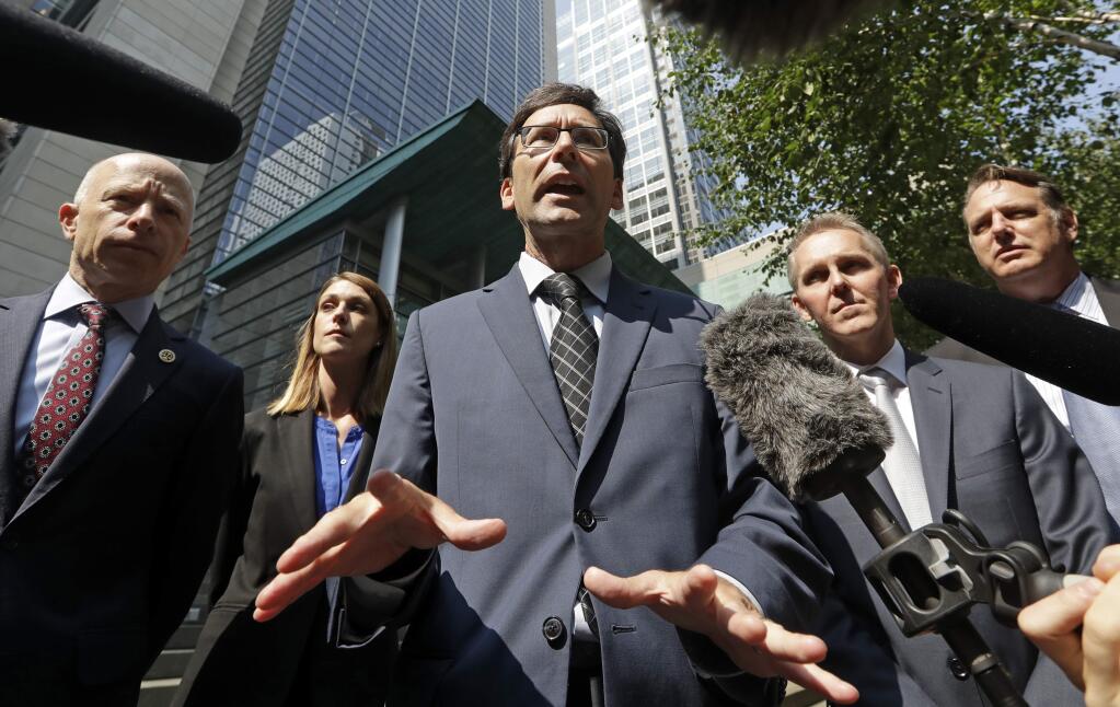 Washington Attorney General Bob Ferguson, center, speaks with media members following a hearing where a federal judge issued a temporary restraining order to stop the release of blueprints to make untraceable and undetectable 3D-printed plastic guns, Tuesday, July 31, 2018, in Seattle. Ferguson was among eight Democratic attorneys general who filed a lawsuit Monday seeking to block the federal government's settlement with the company that makes the plans available online. They also sought a restraining order, arguing the 3D guns would be a safety risk. From left are attorneys Jeff Sprung, Kristin Beneski, Ferguson, Jeff Rupert and Todd Bowers. (AP Photo/Elaine Thompson)