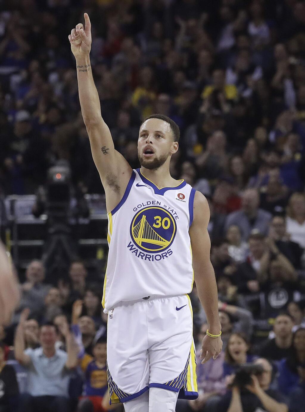 Golden State Warriors guard Stephen Curry (30) reacts after scoring against the Brooklyn Nets during the first half in Oakland, Tuesday, March 6, 2018. (AP Photo/Jeff Chiu)