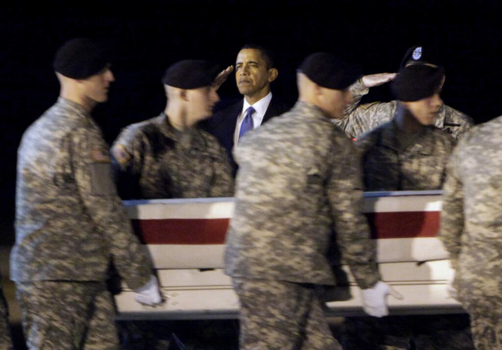FILE- In this Oct. 29, 2009, file photo, President Barack Obama, center, salutes as an Army carry team carries the transfer case containing the remains of Sgt. Dale R. Griffin of Terre Haute, Ind., during a dignified transfer event at Dover Air Force Base, Del. President Donald Trump is claiming his predecessors did not sufficiently honor the nation's fallen. Obama's office says Trump is 'unequivocally wrong,' and says Obama engaged families of the fallen and wounded warriors through his presidency - through calls, letters, visits to Arlington National Cemetery, regular meetings with Gold Star families and more. (AP Photo/Pablo Martinez Monsivais, File)