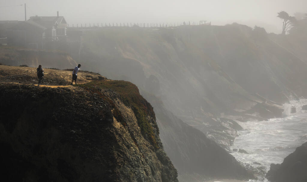 Very few homes remain perched atop eroding bluffs of Gleason Beach, Monday, Oct. 19. 2020 north of Bodega Bay.  The persistent wave action erodes the hillside about a foot per year, encroaching on Highway 1. Caltrans is proposing to reroute the section.  (Kent Porter / The Press Democrat)