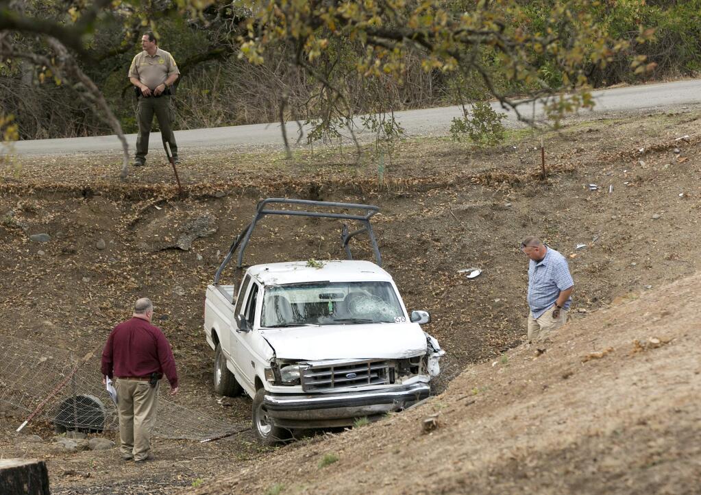 FILE - In this Nov. 14, 2017 file photo, investigators view a pickup truck involved in a deadly shooting rampage at the Rancho Tehama Reserve, near Corning, Calif. Sheriff's deputies responded 21 times in the last year to calls involving a California man who had been feuding with his neighbors before he committed a shooting rampage last week, killing five people and wounding at least eight others. (AP Photo/Rich Pedroncelli)