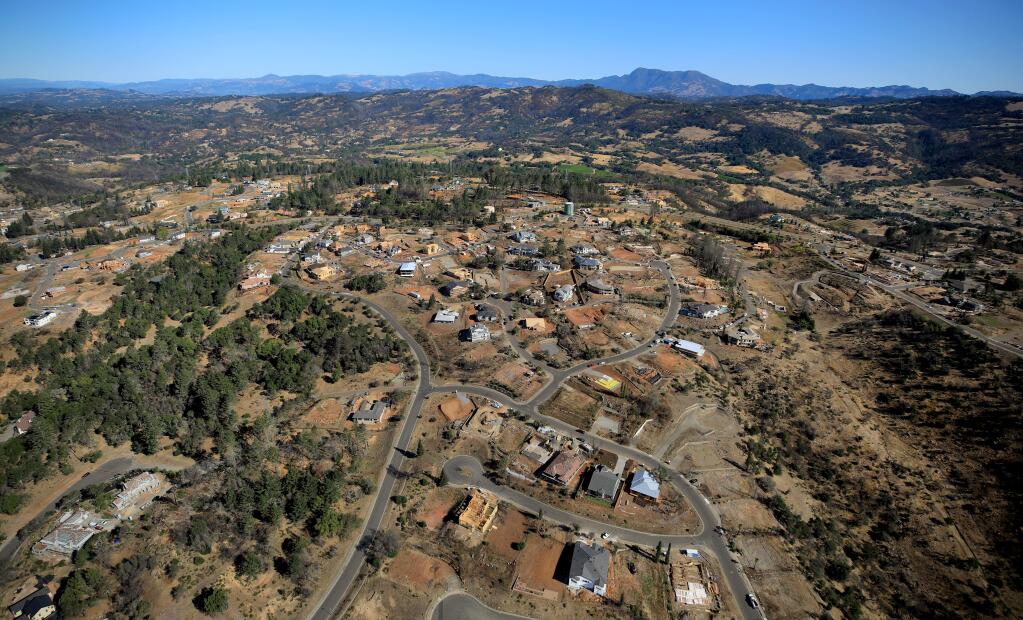 Fountaingrove's Crown Hill neighborhood is slowly being rebuilt. The path of the Tubbs fire can be clearly seen, with Mt. St. Helena in the background. (KENT PORTER / The Press Democrat)
