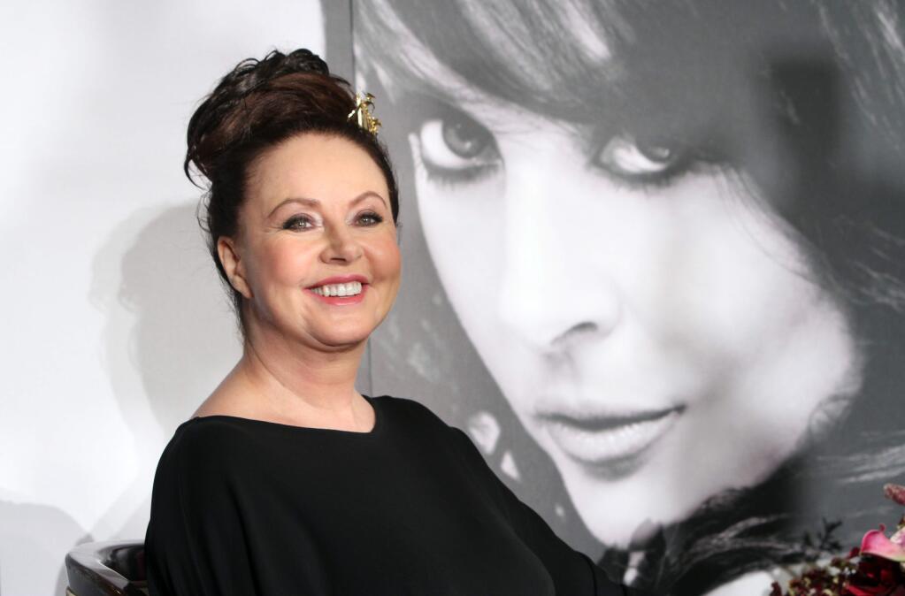 English singer Sarah Brightman smiles during an event to announce her concert in Taipei, Taiwan, Saturday, Dec. 13, 2014. (AP Photo/Chiang Ying-ying)