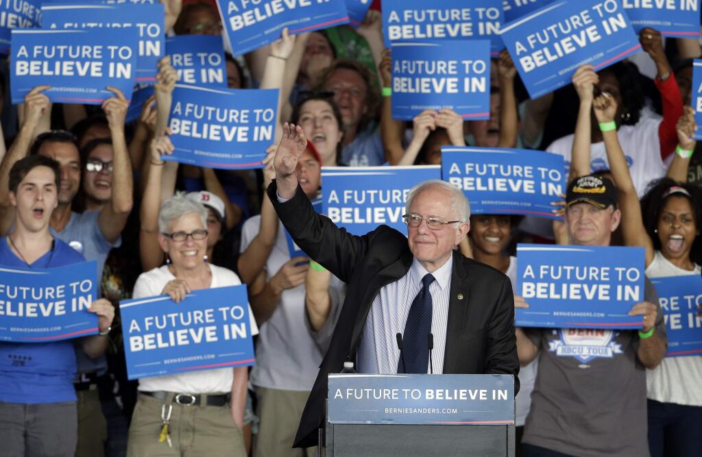 Democratic presidential candidate, Sen. Bernie Sanders, I-Vt., waves to supporters during a rally in Charlotte, N.C., Monday, March 14, 2016. (AP Photo/Chuck Burton)