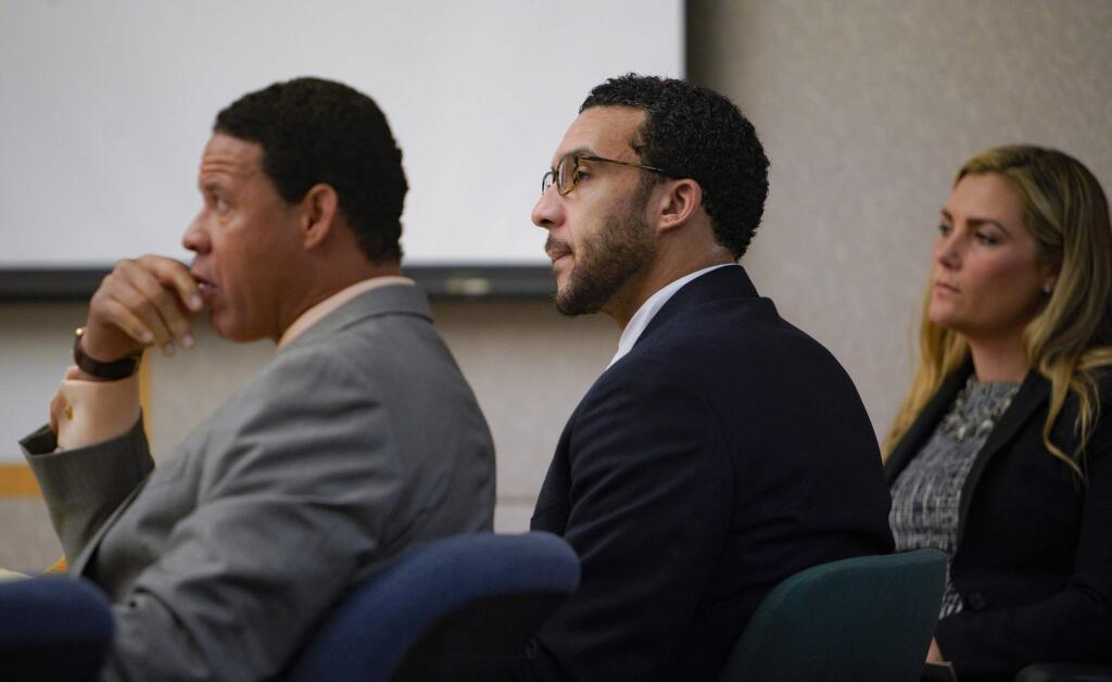 Sitting in Superior Court in Vista, Kellen Winslow, Jr., is flanked by two of his three defense attorneys, Brian Watkins, left, and Elizabeth Bahr, right, as he listens to closing arguments to jury from Deputy District Attorney, Dan Owens on Tuesday, June 4, 2019, in Vista, Calif. (Nelvin C. Cepeda/The San Diego Union-Tribune via AP, Pool)