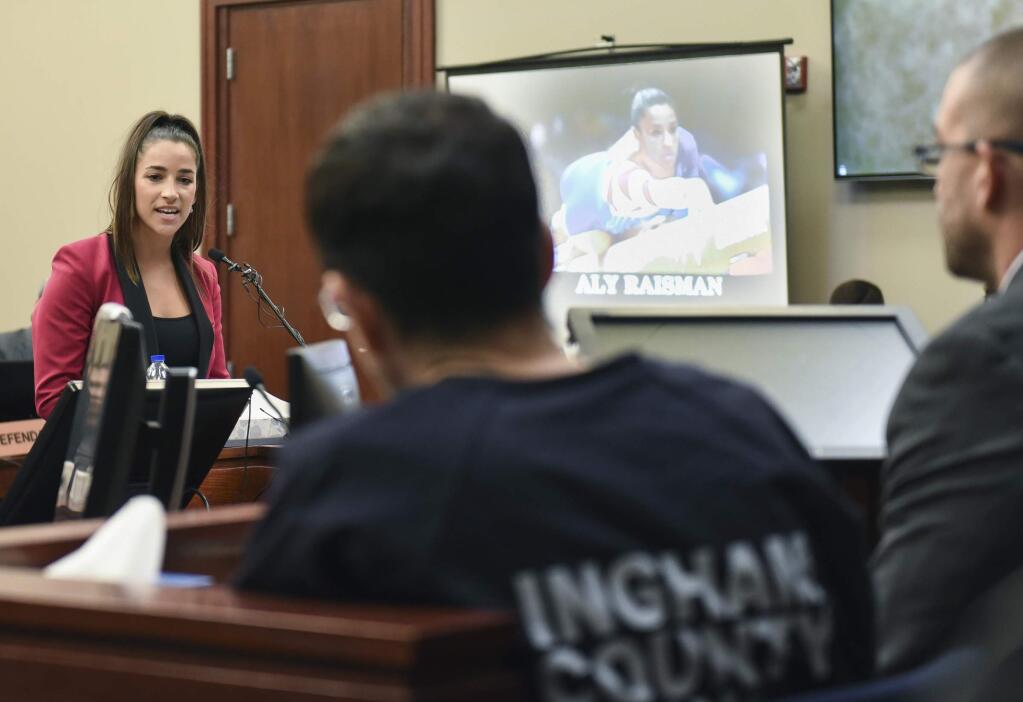 Aly Raisman, an Olympic gymnast in 2012 and 2016, confronts Larry Nassar in a Lansing, Michigan courtroom. Nasser, who was a physician for USA Gymnastics, was sentenced to 40 to 175 years in prison for sexually abusing young athletes in his care. (MATTHEW DAE SMITH / Lansing State Journal)