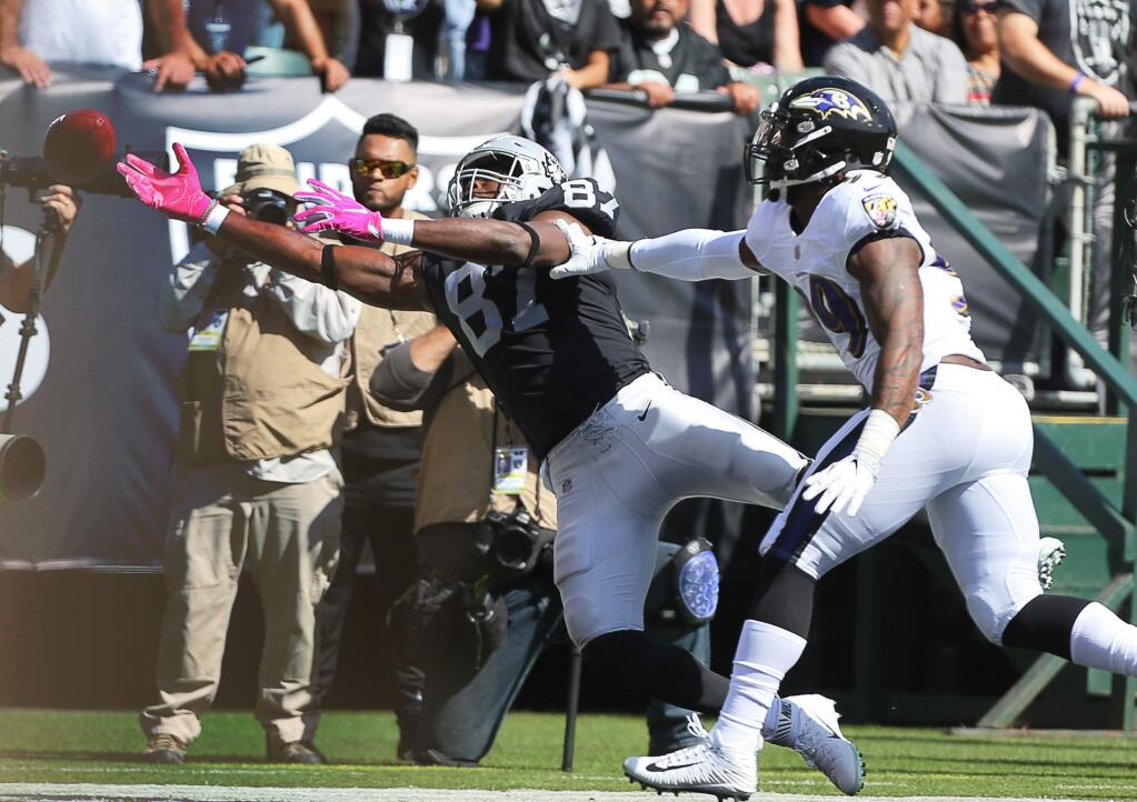 Oakland Raiders tight end Jared Cook is unable to pull in a pass while covered by Baltimore Ravens linebacker Matthew Judon, in Oakland on Sunday, October 8, 2017. (Christopher Chung/ The Press Democrat)