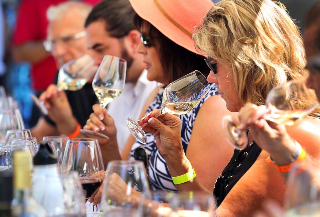 Right to left, Shirley Stiles, Jennifer Piccinini and Liam McCormick learn about everything from glass choice to terroir in a tasting panel lead by Nadia Pavlevska at the Taste of Sonoma at the MacMurray Ranch on Saturday. (John Burgess/The Press Democrat)