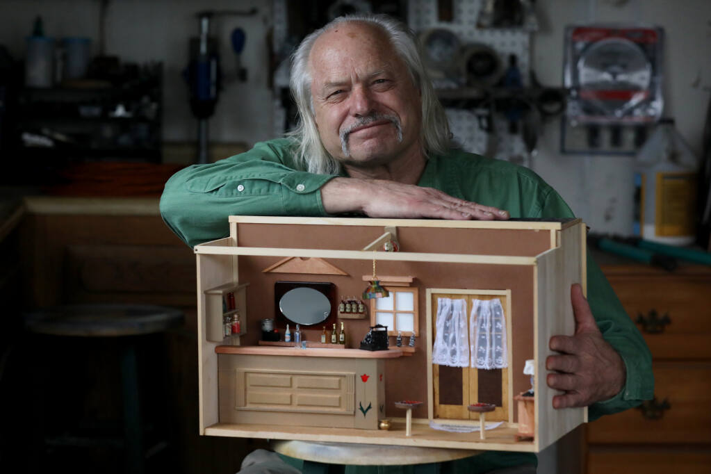 Woodworker Christian Wall holds a model he made of the Philadelphia Saloon, from the turn of the 19th century. Photo taken  in Petaluma, Calif., on Thursday, January 6, 2022.(Beth Schlanker/The Press Democrat)