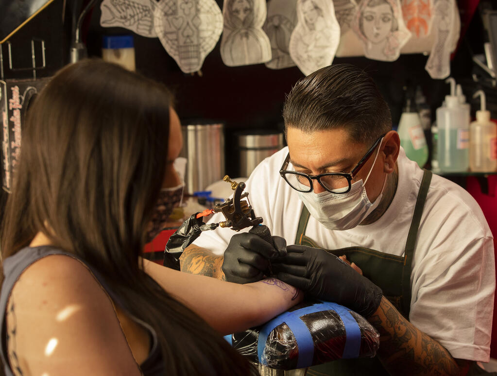 Tattoo artist Brandon Bartholomew, of True Till Death Tattoo & Piercing in Santa Rosa, was finally allowed to go back to work this week after the state and county lifted Coronavirus restrictions.  (John Burgess / The Press Democrat)