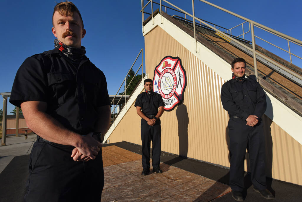Recent graduates, from left, Jerimiah Mahan, 31, Nick Klimenko, 26, and Tyler Neiburger, 30, of the SRJC 99th Fire Academy in Windsor, Calif. on Thursday, May 20, 2021.(Photo: Erik Castro/for The Press Democrat)