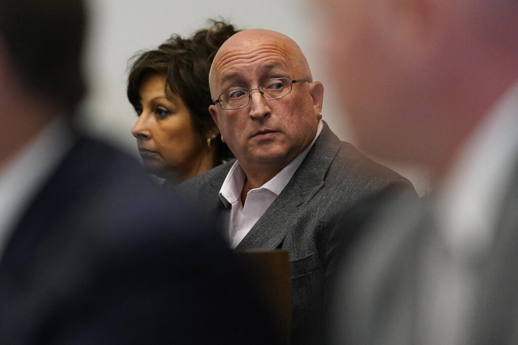 FILE - Robert E. Crimo III's father Robert Crimo Jr., right, and mother Denise Pesina attend to a hearing for their son in Lake County court on Aug. 3, 2022, in Waukegan, Ill. Prosecutors announced Friday, Dec. 16, that Crimo Jr., the father of the Illinois man charged with killing seven people in a mass shooting at a July 4 parade in a Chicago suburb, has been charged with seven felony counts of reckless conduct. (AP Photo/Nam Y. Huh, Pool, File)