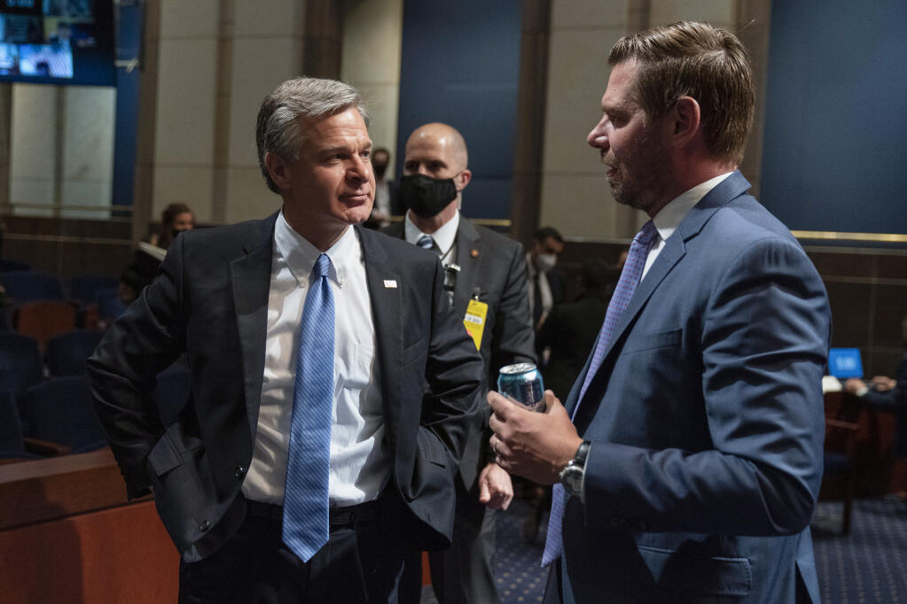 FBI Director Christopher Wray, left, and House Judiciary Committee member Rep. Eric Swalwell, D-Calif., talk during a recess of the committee's oversight hearing on the Federal Bureau of Investigation on Capitol Hill, Thursday, June 10, 2021, in Washington. (AP Photo/Manuel Balce Ceneta)