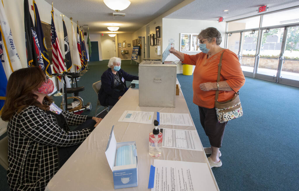 A voter drops off her mail-in ballot at the Sonoma Valley Veterans Memorial Building during early voting on Saturday, Oct. 31. (Photo by Robbi Pengelly/Index-Tribune)